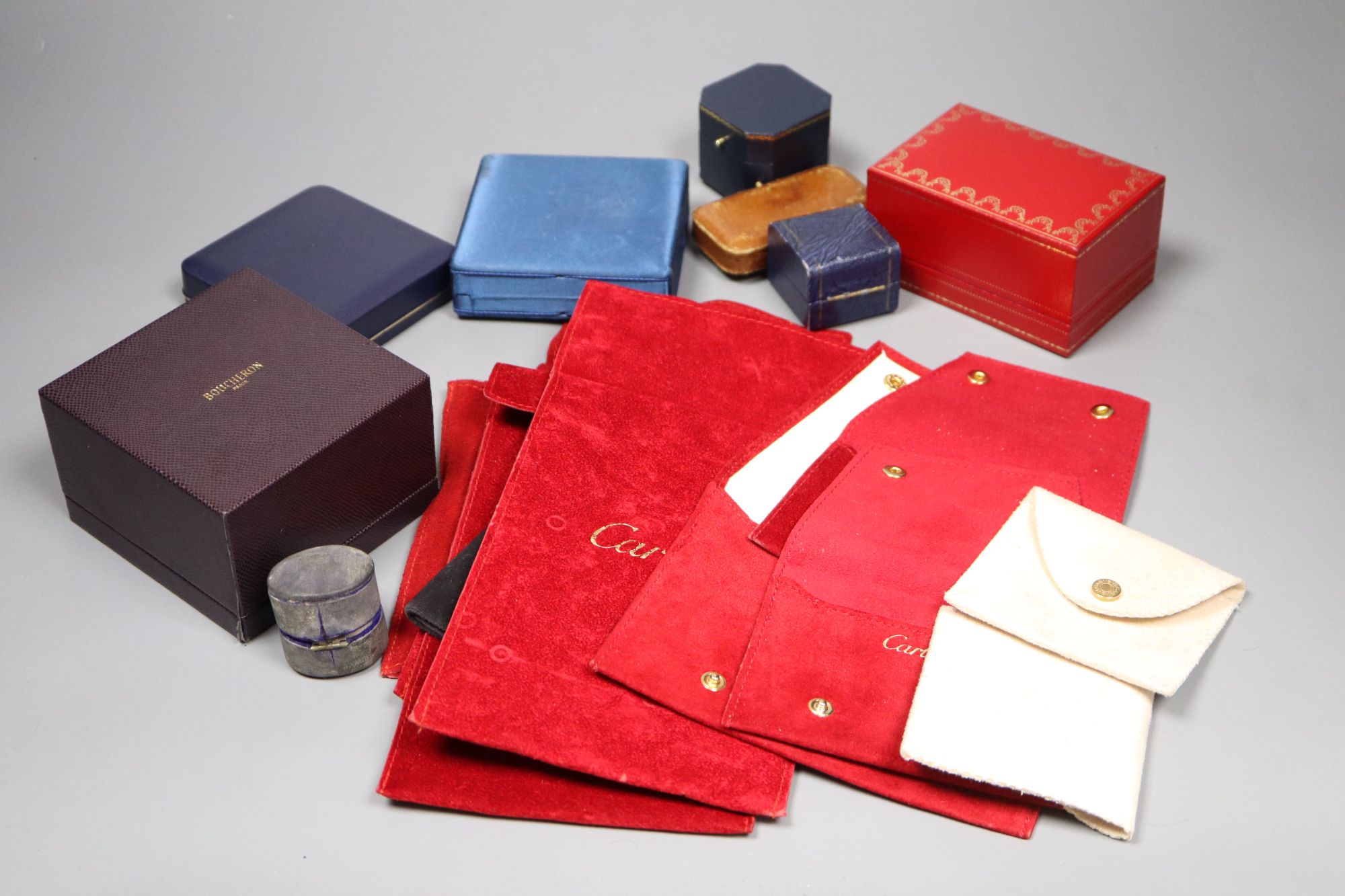 A small group of assorted jewellery boxes including Boucheron & Must de Cartier and seven assorted Cartier velvet pouches.